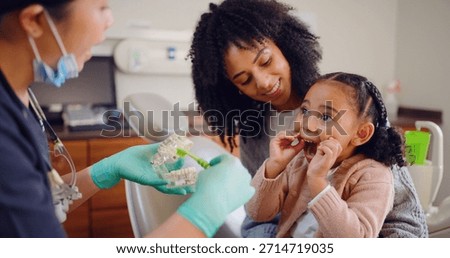 Brushing teeth, consulting or example with dentist, girl and mother in clinic for demonstration. Appointment, dental or mouth model with people in optometry office for advice, checkup or learning
