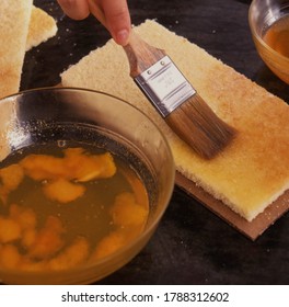 Brusing cake with orange syrup