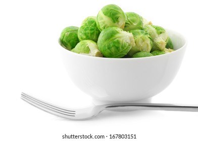 Brussel Sprouts In Bowl And Fork On White Background.