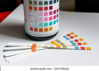 Brussels, Belgium, 1 October 2019 - Water quality measurement test, paper strips with reagents and bottle with marks to check results