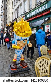 BRUSSELS, BELGIUM -9 FEB 2019- View Of People Eating French Fries, A Belgian Specialty, On The Street In Brussels, Belgium. 