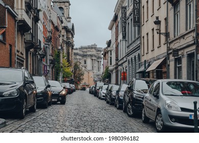 Brussels, Belgium - August 17, 2019: Cars parked on both sides of a narrow street in Brussels, the capital of Belgium and a popular city break destination.