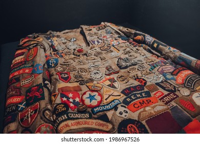 Brussels, Belgium - August 17, 2019: Uniform Patches On A Jacket In The War, Occupation, Liberation New Permanent Collection The Royal Museum Of The Armed Forces And Military History In Brussels.