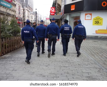 Brussels, Belgium - December 24, 2019: Group Of Back Turned Belgian Policemen Walking. The Politie, Federal Police, Is The Law Enforcement In Belgium