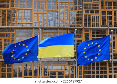 Brussels, Belgium - February 2023, European and Ukrainian flags in front of the European Council  - Shutterstock ID 2266437927