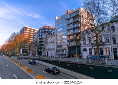 BRUSSELS, BELGIUM - Jan 06, 2022: A City Urban Road With Cars And Buildings With Trees In Brussels Under A Blue Sky