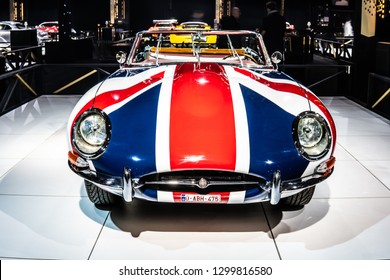 Brussels, Belgium, Jan 18, 2019: vintage Jaguar E Type 1967 glossy and shiny old classic retro auto at Brussels Motor Show, Dream Cars, Great Britain flag 