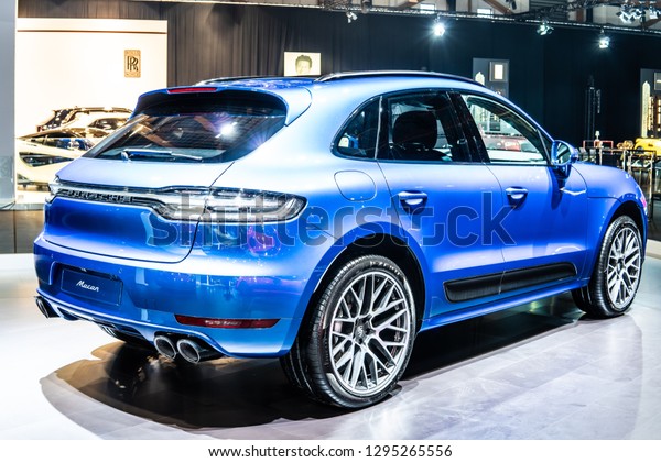 Brussels,\
Belgium, Jan 18, 2019: all new blue Porsche Macan 2019 model at\
Brussels Motor Show, five-door luxury crossover utility vehicle CUV\
produced by the German car manufacturer\
Porsche
