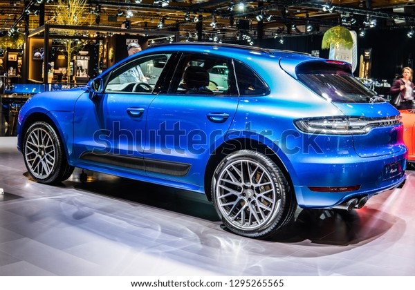 Brussels,\
Belgium, Jan 18, 2019: all new blue Porsche Macan 2019 model at\
Brussels Motor Show, five-door luxury crossover utility vehicle CUV\
produced by the German car manufacturer\
Porsche