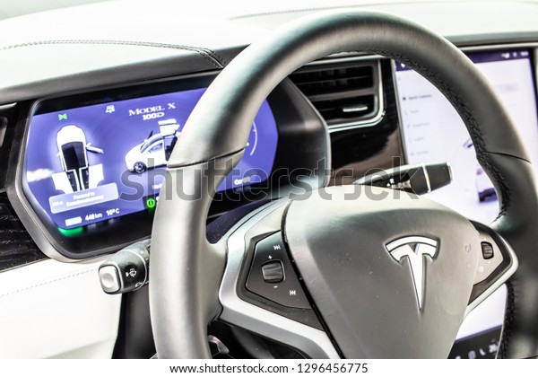 Brussels, Belgium, Jan 18, 2019: metallic white\
Tesla Model X at Brussels Motor Show, produced by American\
automaker Tesla, main shareholder Elon Musk, control board,\
steering wheel, upholstery,\
seats