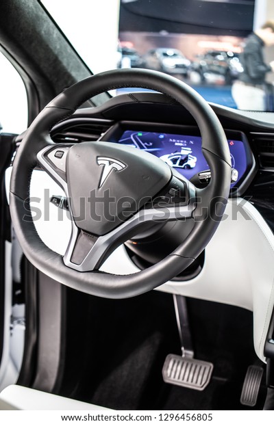 Brussels, Belgium, Jan 18, 2019: metallic white\
Tesla Model X at Brussels Motor Show, produced by American\
automaker Tesla, main shareholder Elon Musk, control board,\
steering wheel, upholstery,\
seats