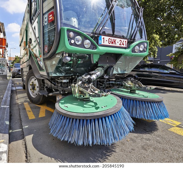 BRUSSELS, BELGIUM - JULY 17, 2014:\
Process of urban street cleaning. Municipal machanical truck at\
Square du Chatelain in Ixelles on July 17 in\
Brussels.