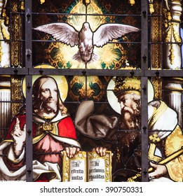 BRUSSELS, BELGIUM - JULY 26, 2012: Stained Glass window of the Holy Trinity, Father, Son and Holy Spirit, in the Cathedral of Brussels, Belgium.