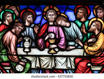BRUSSELS, BELGIUM - JULY 26, 2012:  Stained glass window depicting Jesus and the twelve apostles on maundy thursday at the Last Supper in the cathedral of Brussels, Belgium.