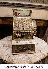 Brussels / Belgium - October 07 2019: Ancient Counting Machine In Front Of Old Fire Place. Decorative Element Of The Interior Of Chocolate Shop. Buttons Above, Drawer Below, Text National On It.