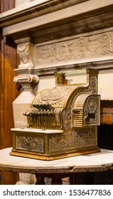 Brussels / Belgium - October 07 2019: Ancient Counting Machine In Front Of Old Fire Place. Decorative Element Of The Interior Of Chocolate Shop. Buttons Above, Drawer Below, Text National On It.