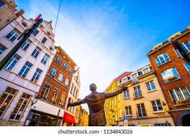 Brussels (Bruxelles), Belgium - March 21, 2018 - Place de la Vieille Halle aux Bles with statue of the famous singer Jacques Brel, which entitled L'envol (The Flight)