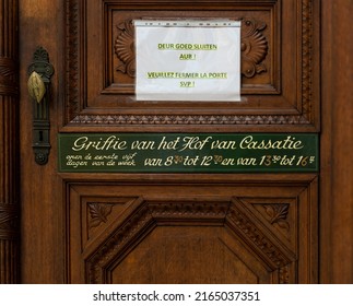 Brussels Capital Region - Belgium - 06 05 2022 - Wooden Sign Indicating The Opening Hours Of The Clerk Of The Court Of Cassation