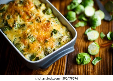 Brussels sprouts baked in sauce with cheese in a ceramic form