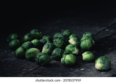 Brussels Sprouts Cabbage On Old Wooden Table.Dark Mood Food Photography.