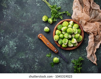 Brussels sprouts on green concrete background. Top view