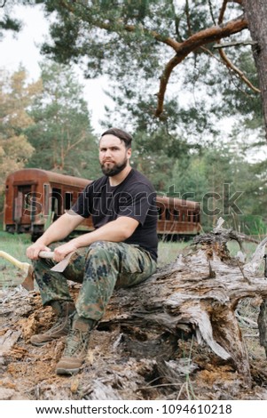 Similar – Foto Bild bärtiger Holzfäller mit einer Axt, die neben einem rostigen Zug sitzt.