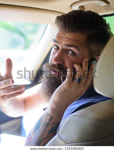 brutal caucasian hipster with\
moustache. Mature hipster with beard. Male barber care. Bearded\
man. Taxi. traffic jam on road. time. gas station. Welcome on\
board.