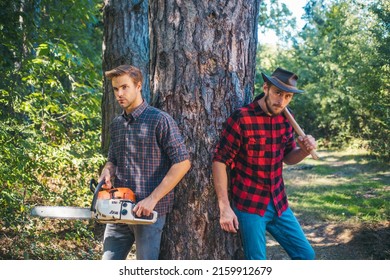 Brutal lumberjacks. Cutting wood. Brutality and masculinity. Lumberjack style. Man woodcutter with axe. Strong man with axe.