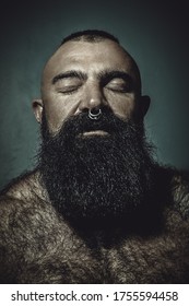 Brutal Man With A Long Black Beard And A Nose Ring Closed His Eyes