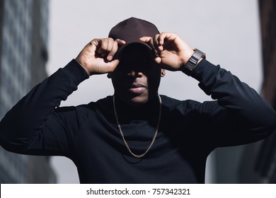 Brutal Man Rapper With Cap Posing In City