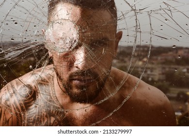 Brutal man, serious face of handsome male model, concept of men power and strong. Gangster man. Dangerous criminal, hooligan guy on cracked bullet glass. - Shutterstock ID 2133279997