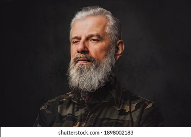 Brutal Martial Grandfather Dressed In Military Clothing Poses In Dark Background. Headshot Of Old Man.