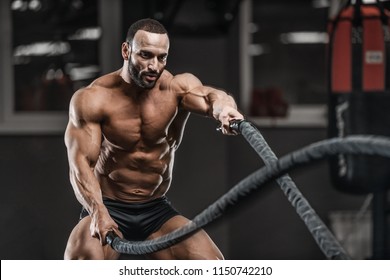 Brutal Strong Bodybuilder Athletic Man Pumping Up Muscles Workout Bodybuilding Concept Background - Muscular Bodybuilder Handsome Men Doing Exercises In Gym Naked Torso Sport And Diet Concept