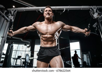 Brutal strong bodybuilder athletic man pumping up muscles workout bodybuilding concept background - muscular bodybuilder handsome men doing exercises in gym naked torso