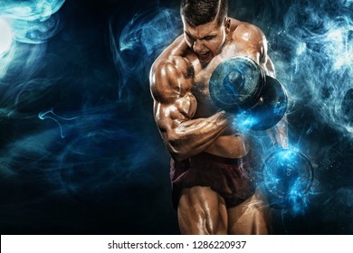 Brutal strong muscular bodybuilder athletic man pumping up muscles with dumbbell on black background. Workout bodybuilding concept. Copy space for sport nutrition ads.