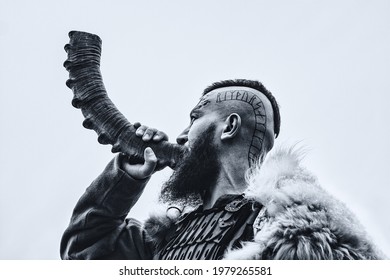 Brutal Viking Warrior Blowing Horn Outdoors.