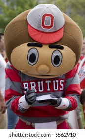 Brutus the Buckeye at Ohio State signs an autograph for a fan