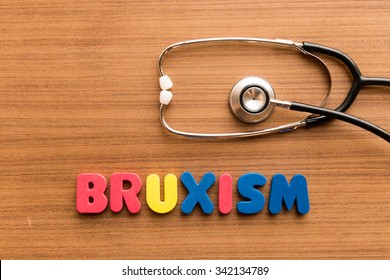Bruxism  colorful word on the wooden background with stethoscope