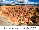 Bryce Canyon Amphitheater panorama view from Inspiration Point at sunrise, Bryce Canyon National Park, Utah, USA. Red rock hoodoos stone garden in Bryce Canyon. Summer day with blue sky and clouds.