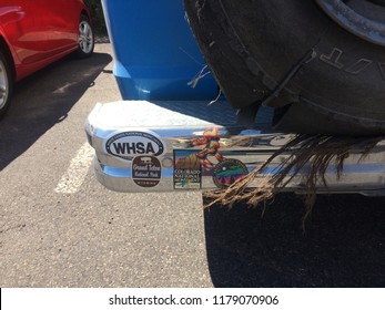 Bryce Canyon, UT/USA - September 10, 2018: Closeup Of Travel Related Bumper Stickers On A Blue Van With A Shredded Spare Tire And Steel Belts Hanging Out