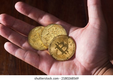 BTC Cyrpto currency coin in man hand 