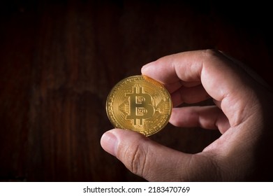 BTC Cyrpto currency coin in man hand