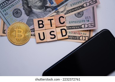 BTC USD inscription next to US dollars and bitcoin coin. Bitcoin dollar exchange rate. Drop in cryptocurrency prices