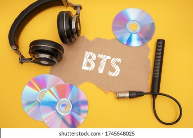 BTS Concept With Headphones And Music Discs On A Yellow Background.