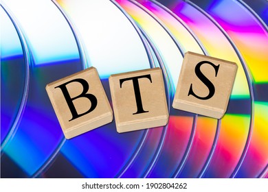 BTS concept with wooden cubes. BTS word on CD background