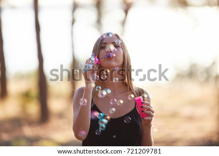 Similar – Young teenage girl blowing pink bubble gum