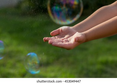 bubble at the hands of a little girl