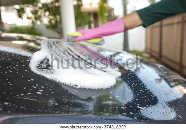 Bubble\
on black car during car washing. Cleaning\
concept.