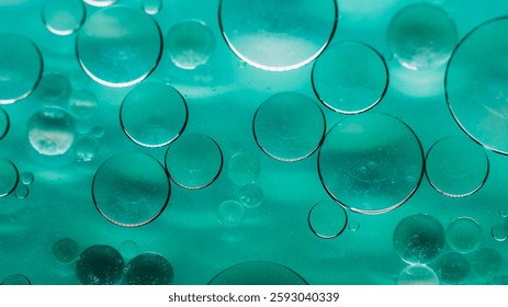 Bubble paint. Drop background. Defocused green color ink in water sparkling oil round fluid flow emulsion spilling on abstract art.