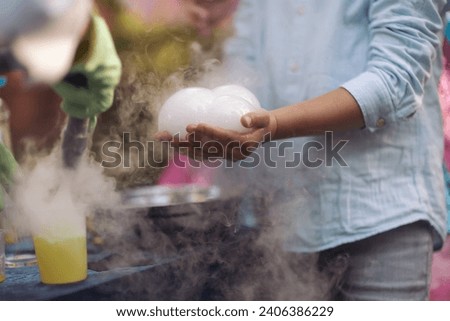 a bubble with steam in hands of a kid,science experiment. Nitrogen scientific experiments and show, shows for people and children. Chemical experiments. Foam and smoke after the experiments. Chemistry
